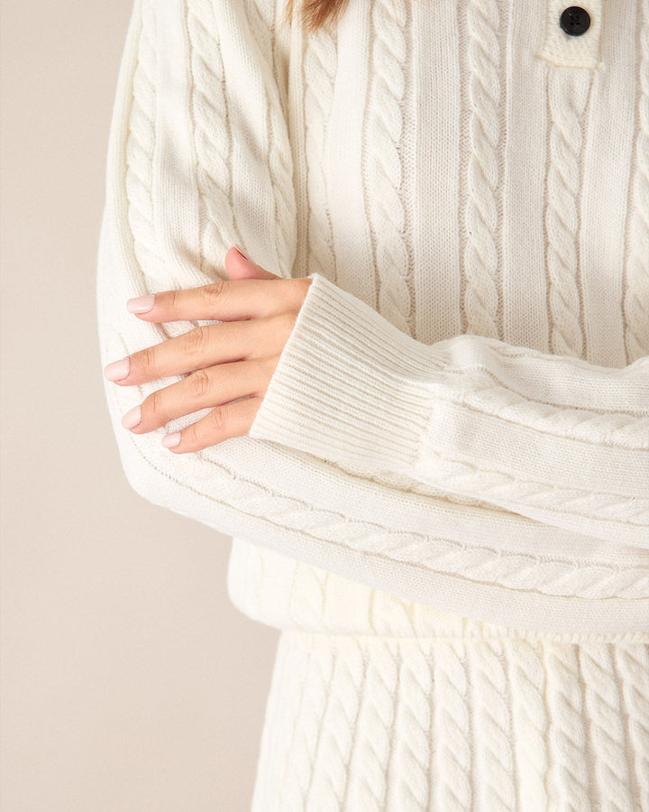 Weißer Pullover mit auffälligen Kontrastknöpfen